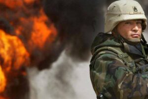 u-s-army-staff-sergeant-robert-dominguez-stands-guard-next-to-a-burning-oil-well-on-march-27-2003-in-rumayla-iraq