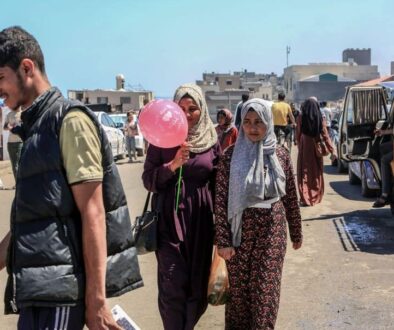 palestinians-walk-on-a-street-in-deir-al-balah-in-the-central-gaza-strip