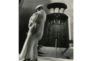 Trinity-Baptist-Church-built-circa-1931.-Trinity-Baptist-Church-250-East-61st-St.-art-nouveau-detailing.-Model-in-mid-1930s-fashion-white-monkey-fur-jacket-and-crepe-bias-cut-dress