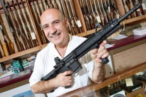 gun-store-owner-holding-assault-semi-automatic-rifle