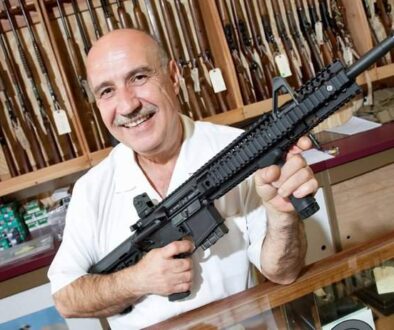 gun-store-owner-holding-assault-semi-automatic-rifle