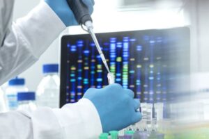 Scientist pipetting sample into a vial for DNA testing