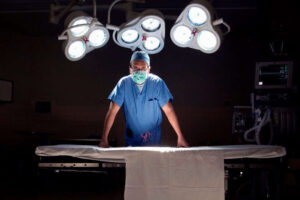 Surgeon in operating room wearing surgical mask, portrait