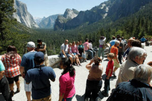 Park visitors gather at Tunnel View observation point, at Yosemite National Park, on Saturday May 12, 2012. Visitors to California national parks may notice more trash on trails, longer lines at service booths and fewer rangers this summer as the pinch of