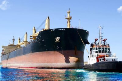 Tugboat helping ship in the harbor