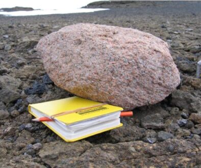 Pink-Granite-Boulder-Next-to-a-Yellow-Notebook-777x584-1