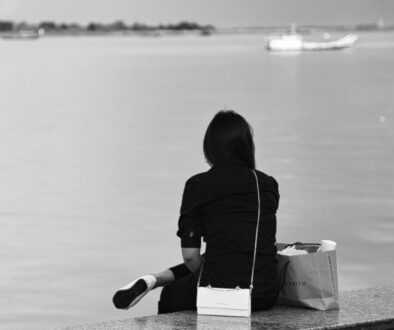 lady-sitting-by-Tonle-Sap-riverside-1024x1436-1